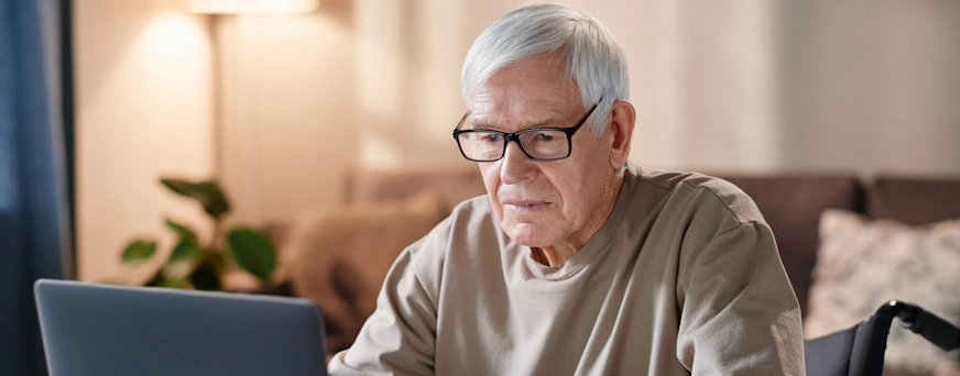 Life Assure Senior Researching On Computer At Home Hero